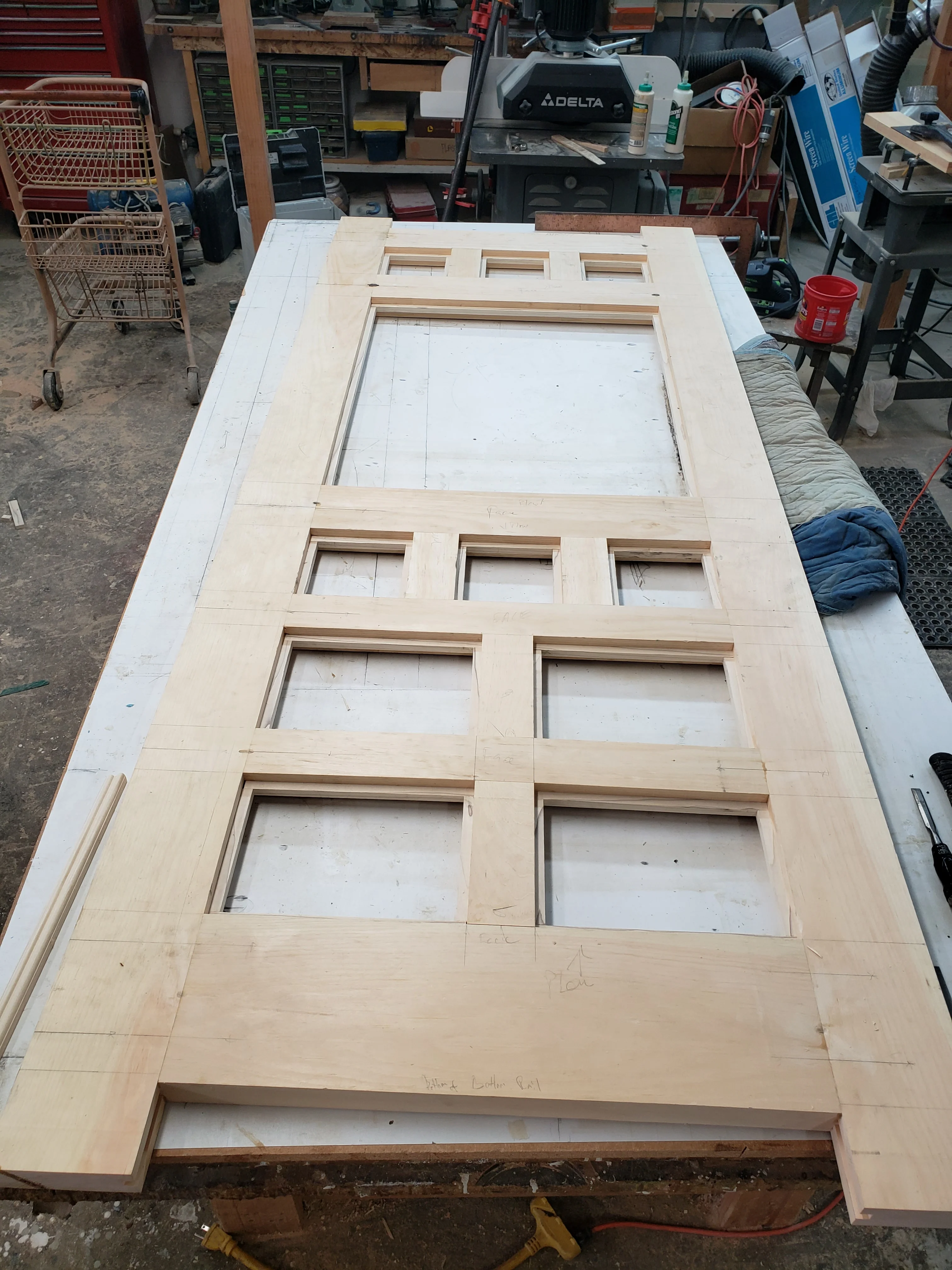 Unfinished solid wood six-panel interior door with routed details in workshop